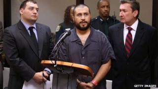George Zimmerman (C), the acquitted shooter in the death of Trayvon Martin, answers questions from a Seminole circuit judge during a first-appearance hearing on charges including aggravated assault stemming from a fight with his girlfriend in Sanford, Florida 19 November 2013