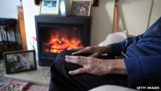 A pensioner with his gas fire on