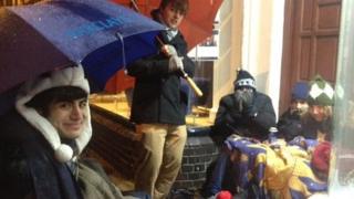 Students outside estate agency