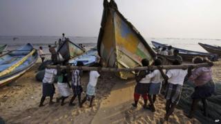 Indian fishermen move boats away from the coast following a cyclone warning in Orissa on 26 November 2013