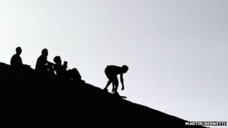Tourists sandboarding (generic)