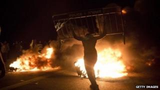 Israel Bedouins burn a police barricade during a protest on 30 November 2013 near Hura, Israel