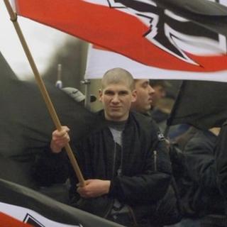 Demonstrator holds a German Reich war flag