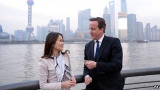 David Cameron talks to Lisa Pan, vice-president of games manufacturer Rekoo, in Shanghai