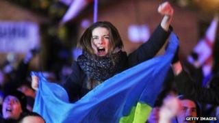 A protester holds a Ukrainian flag during an opposition rally on December 3, 2013.