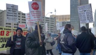 Protestors holding signs outside Detroit courthouse
