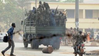 Soldiers crowd a truck in a street of Bamako on March 22, 2012.