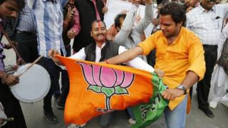 India's main opposition Bharatiya Janata Party (BJP) supporters celebrate the party's victory in various state Assembly elections in Allahabad, India, Sunday, Dec. 8, 2013.
