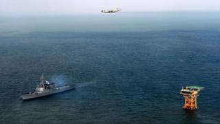 This picture taken on December 2, 2013 shows the South Korean Navy patrol-aircraft P-3C and South Korean Aegis DDG-992 during defence operations near Ieodo Ocean Research Station.