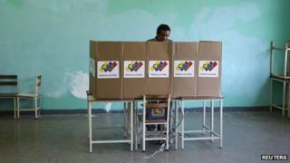 A man votes during municipal elections in Caracas on 8 December, 2013