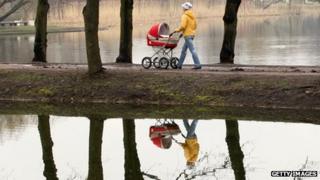 A woman pushing a baby buggy