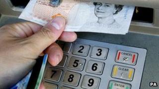 Person withdrawing cash from an ATM (generic)