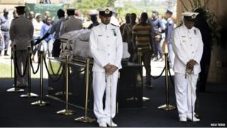 Sailors stand beside the coffin of Nelson Mandela lying in state at the Union Buildings in Pretoria on 11 December 2013