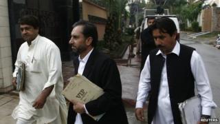 Samiullah Afridi (centre) in October 2013 arrives in court in Peshawar