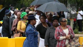 Visitors line up to view the body of former South African president Nelson Mandela as he lies in state at the Union Buildings on December 12, 2013 in Pretoria, South Africa.