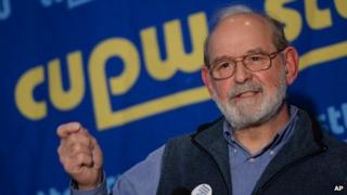 Canadian Union of Postal Workers National President Denis Lemelin gestures during a news conference in Ottawa 11 December 2013