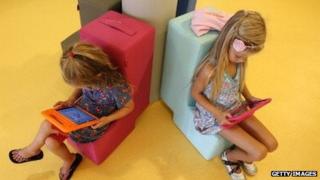 Dutch children look at tablet computers at their school on August 21, 2013.