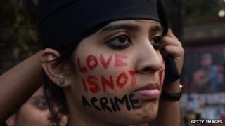 An Indian gay-rights protester has "love is not a crime" written on her face.