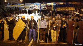 Pro-EU protesters guard a barricade near the Independence Square in Kiev. Photo: 15 December 2013