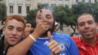Three men take part in a pot legalisation march in Montevideo on May 5, 2012
