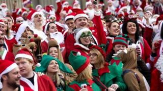 Santa-clad partiers flock to central London for the 2013 Santacon.