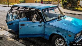 A man rests in a car front the Moncada Barracks in Santiago de Cuba, on July 23, 2013
