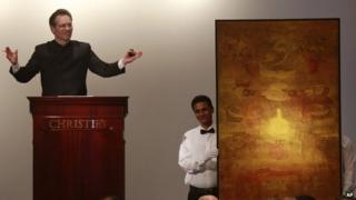 Christie’s International Director, Asian Art, Hugo Weihe, left, acts as auctioneer for the painting of Indian artist Vasudeo S. Gaitonde during Christie"s first auction in India in Mumbai, Thursday, Dec. 19, 2013.