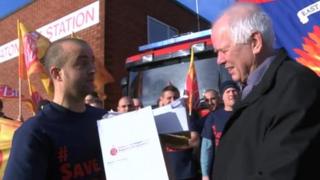 Chris Tapp from the Fire Brigades Union handing the petition over to fire authority chairman Roland Hosker on Friday
