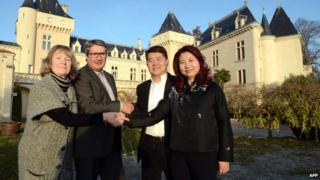 James Gregoire and Lam Kok with their wives outside the Chateau de la Riviere on 20 December 2013