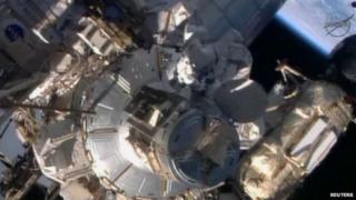 Astronauts repairing the International space Station