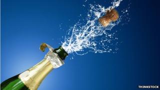 champagne cork shooting out of bottle