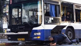 Israeli police inspect the bomb-damaged bus in Bat Yam (22 December 2013)