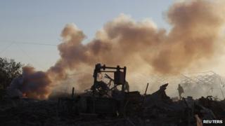 A Palestinian inspects a Hamas training camp after it was hit by an Israeli air strike in Khan Younis in the southern Gaza Strip