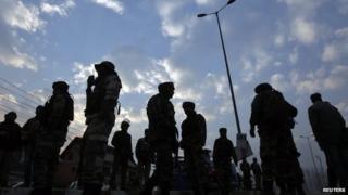 Indian army soldiers stand guard after a shootout in Srinagar December 11, 2013. A Central Reserve Police Force (CRPF) officer was killed and another injured after militants opened fire on a CRPF patrol, police said.