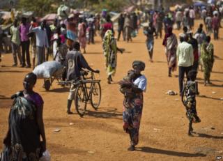 People walk through a camp for displaced people in Juba, South Sudan, 27 December