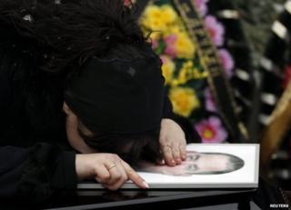 A relative grieves over the coffin of a victim of the Volgograd attacks, 31 December