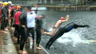 Swimmers dive in