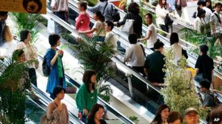 File photos of shoppers in Yokohama, near Tokyo