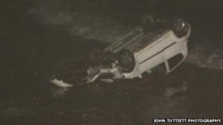 The car on its roof in the waves
