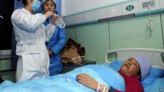 An injured woman receives medical treatment at a hospital in Xiji Town in Guyuan, in Ningxia region, on 7 January 2014