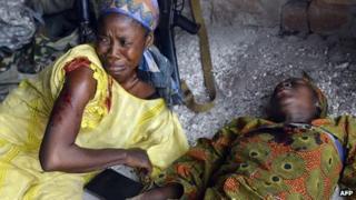 Two wounded women are pictured after a grenade was thrown at the Kokoro market in the Km 5 district of Bangui on 5 January