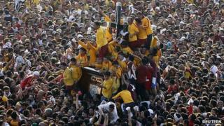 Devotees crowd around the Black Nazarene statue in Manila
