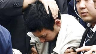 Rape suspect Yuta Sugimoto is captured by police, in Kawasaki, Japan, on 9 January 2014