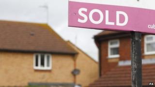 A "sold" sign outside a house