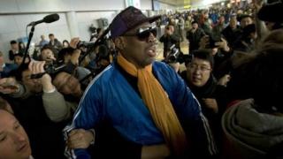 Former NBA basketball player Dennis Rodman is followed by journalists as he arrives at the Capital International Airport in Beijing from Pyongyang, Monday, 13 January 2014