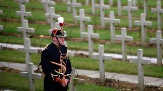 A French soldier stands in front of World War One graves in Douaumont, France.