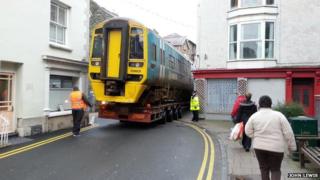 Train being moved through streets of Barmouth, Wales