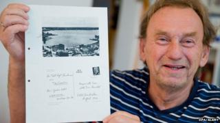 Guenter Zettl with a page from his Stasi file