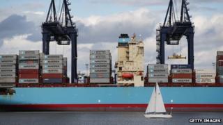 Yacht sales past container ship