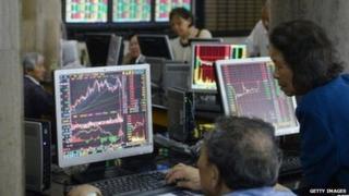 People looking at stocks in Shanghai